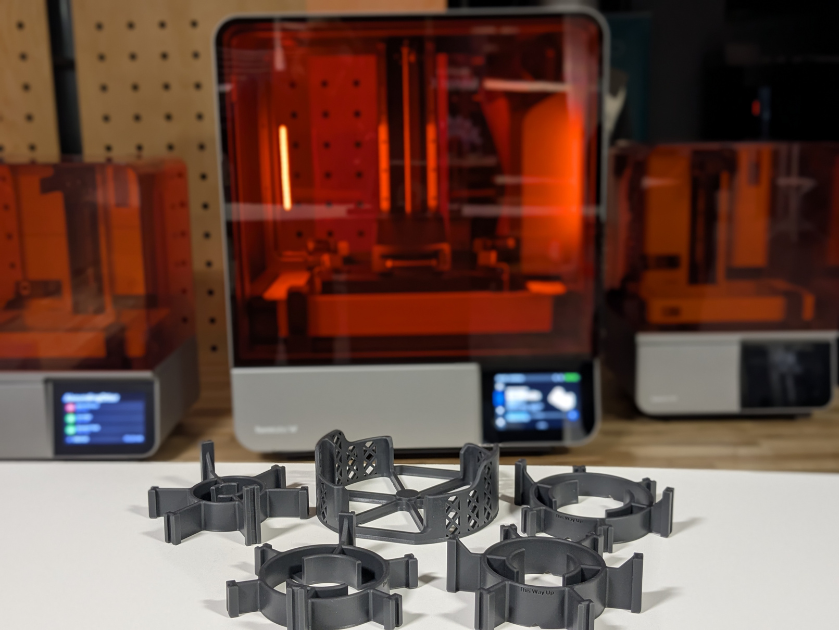 3D printed pucks with master in front of Formlabs Form 4L